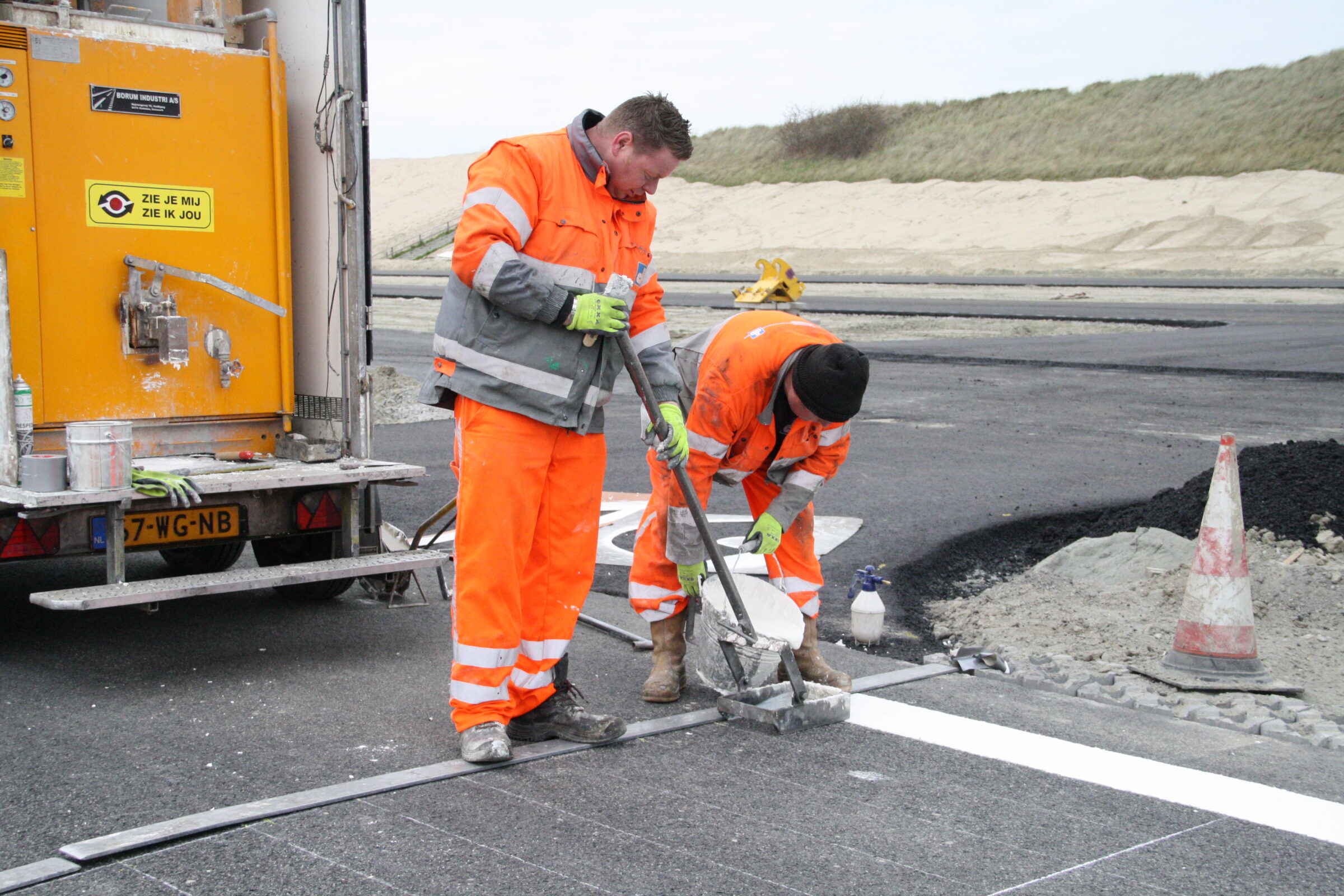 Medewerkers H4A Openbare Ruimte wegmarkeringen brengen lijnen aan